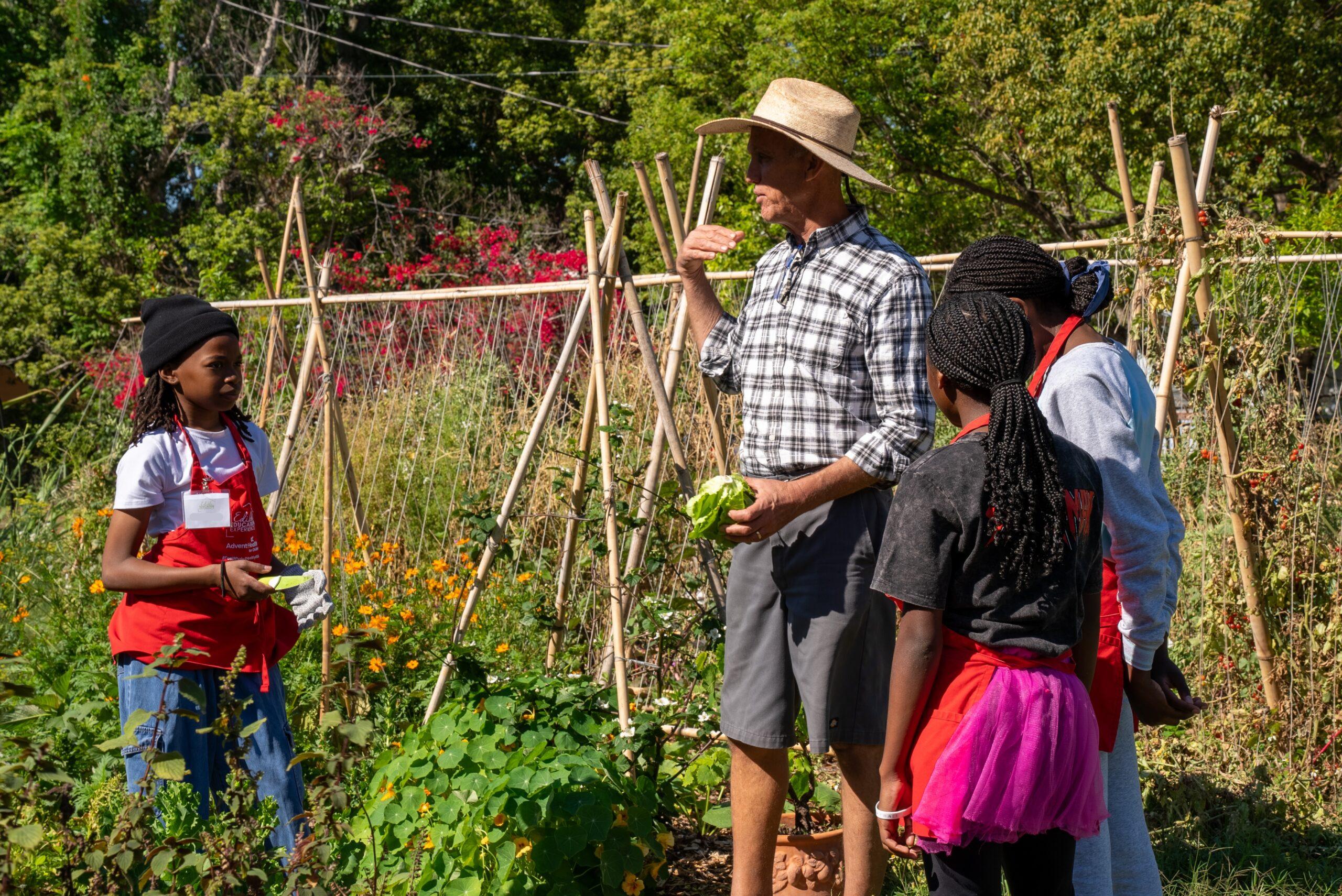 Teacher instructing students in the garden